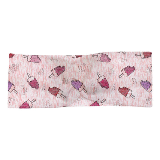 Knotenhaarband "Eis am Stiel" für Babys und Kinder. Auf dem rosa-weiß-melierten Stoff befindet sich ein Eis-am-Stiel-Motiv in den Farben rosa, rot und flieder. Außerdem sind silberne Glitzerpunkte aufgebracht.