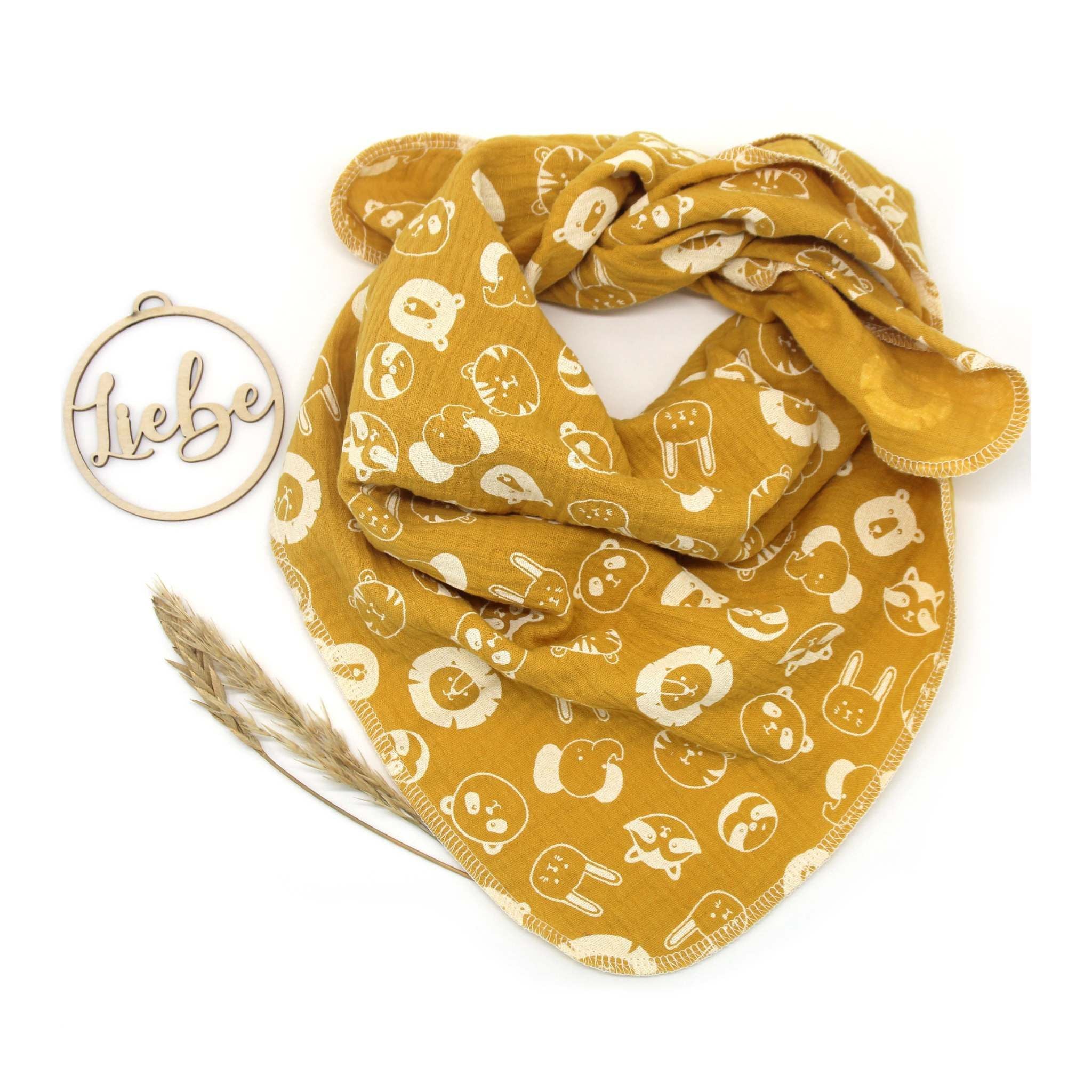 Musselintuch für Kinder in senf mit weißen Tiergesichtern.